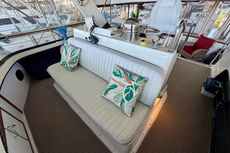 Slide: The Image of 1987 Carver 4207 Aft Cabin Motor Yacht interior with seating and decorative pillows. - 20