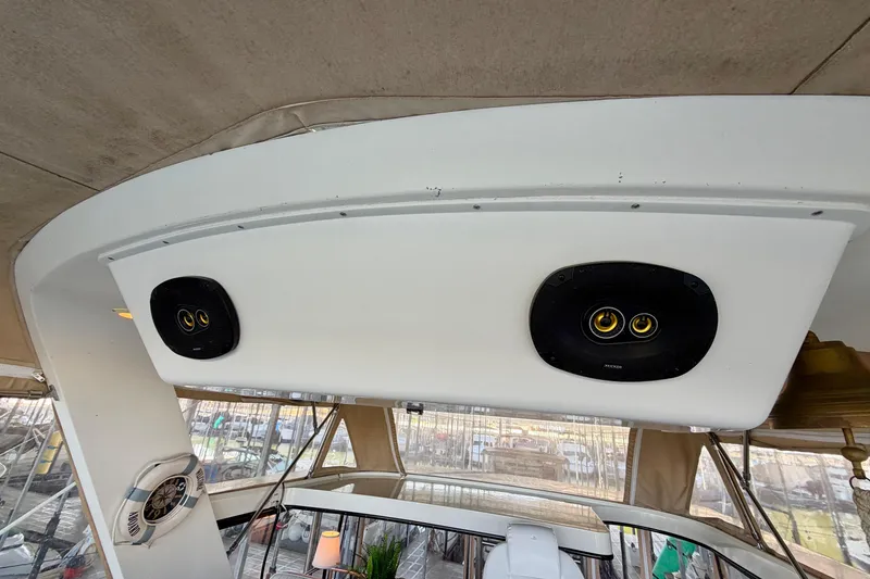 Slide: The Image of 1987 Carver 4207 Aft Cabin Motor Yacht interior with speakers and helm view. - 22