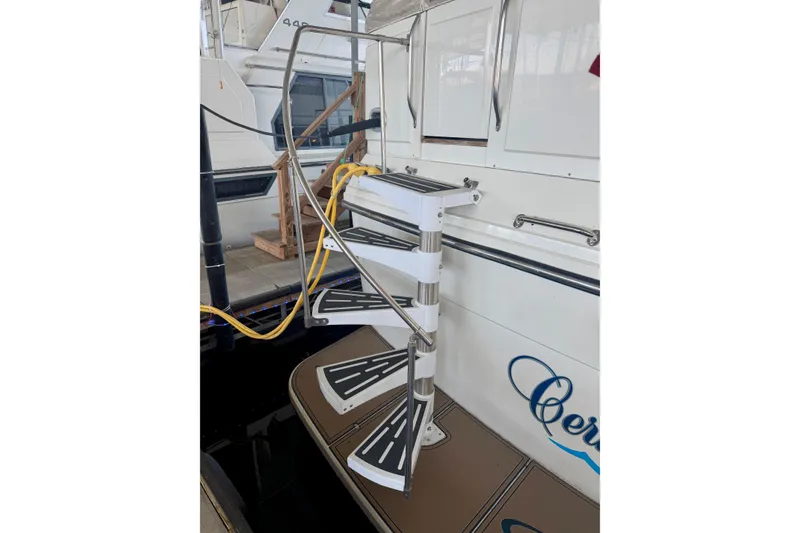 Slide: The Image of 1987 Carver 4207 Aft Cabin Motor Yacht with spiral staircase and docked setting. - 3