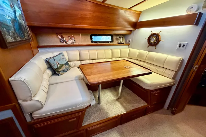 Slide: The Image of 1987 Carver 4207 Aft Cabin Motor Yacht interior with cozy dining area and nautical decor. - 32