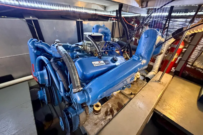 Slide: The Image of Engine room of 1987 Carver 4207 Aft Cabin Motor Yacht with blue Crusader engine. - 55