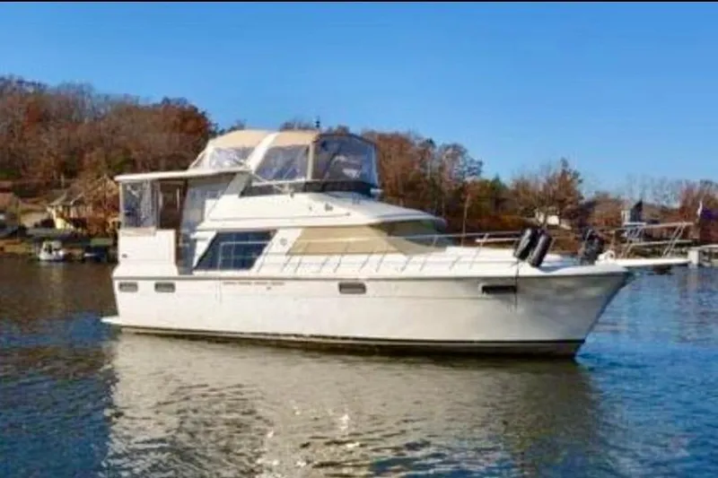The Image of 1987 Carver 4207 Aft Cabin Motor Yacht on a serene lake. - 0