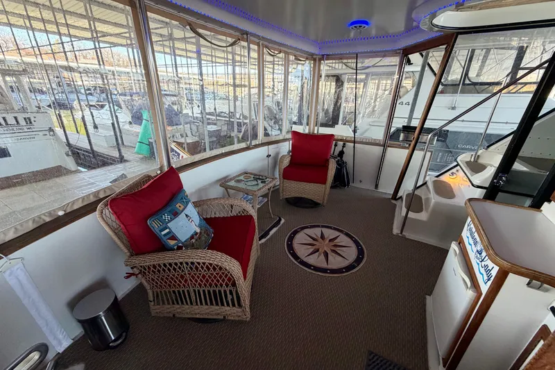 Slide: The Image of 1987 Carver 4207 Aft Cabin Motor Yacht interior with wicker chairs and nautical decor. - 14