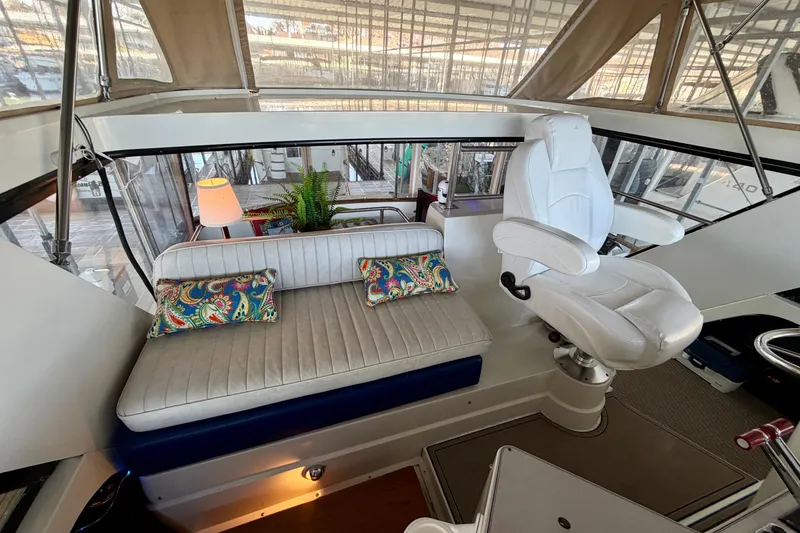 Slide: The Image of 1987 Carver 4207 Aft Cabin Motor Yacht interior with seating and helm station. - 21