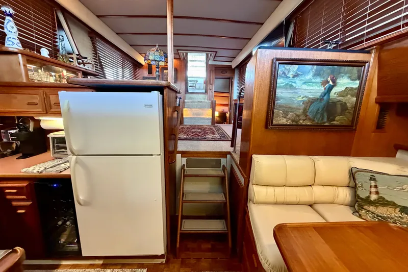 Slide: The Image of Interior of 1987 Carver 4207 Aft Cabin Motor Yacht with cozy seating and kitchen area. - 35