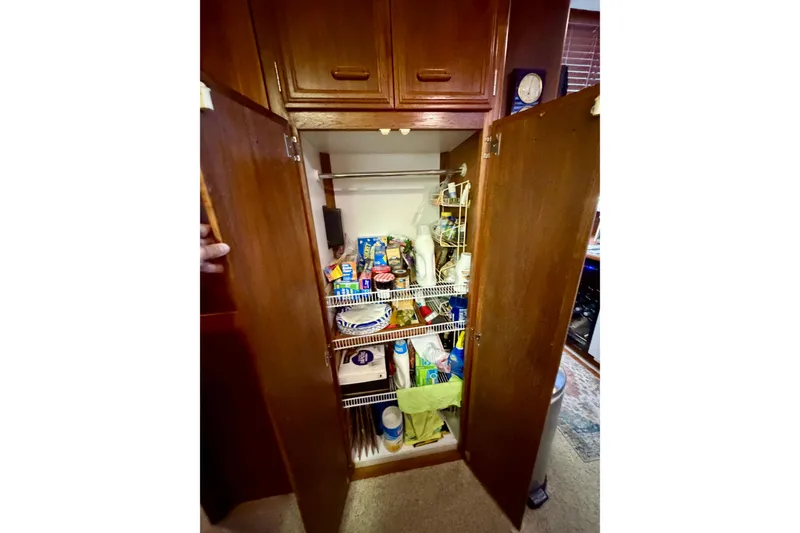 Slide: The Image of Open pantry in 1987 Carver 4207 Aft Cabin Motor Yacht, stocked with various food items. - 36