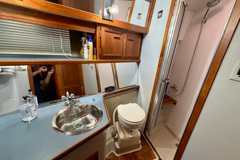 Slide: The Image of 1987 Carver 4207 Aft Cabin Motor Yacht bathroom with sink, toilet, and shower. - 39