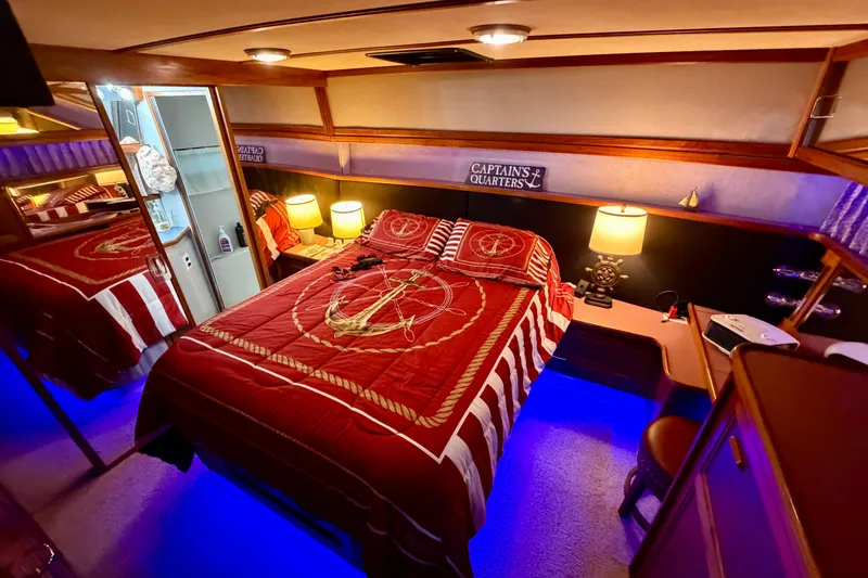 Slide: The Image of 1987 Carver 4207 Aft Cabin Motor Yacht interior with nautical-themed bedroom decor. - 42