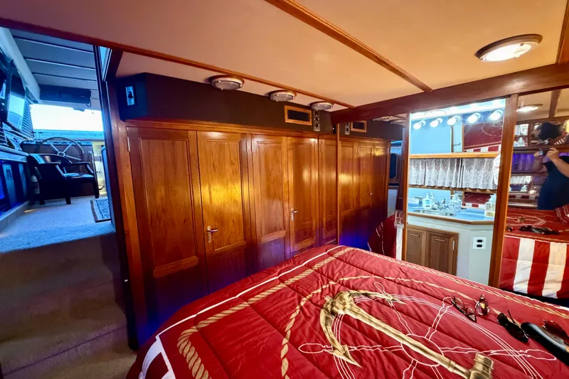 Slide: The Image of Luxurious 1987 Carver 4207 Aft Cabin Motor Yacht interior with wood paneling and cozy bedroom. - 44