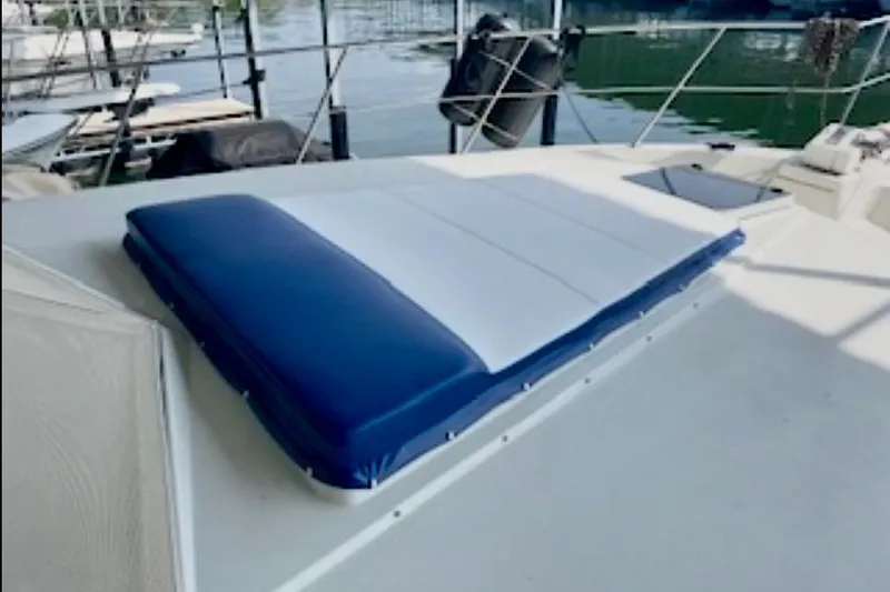 Slide: The Image of 1987 Carver 4207 Aft Cabin Motor Yacht deck with blue and white cushion. - 5