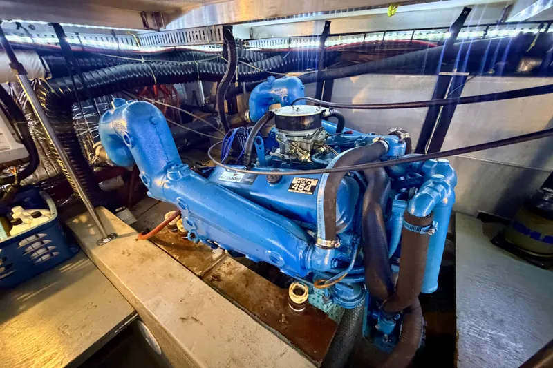Slide: The Image of Engine room of 1987 Carver 4207 Aft Cabin Motor Yacht with blue Crusader engine. - 54