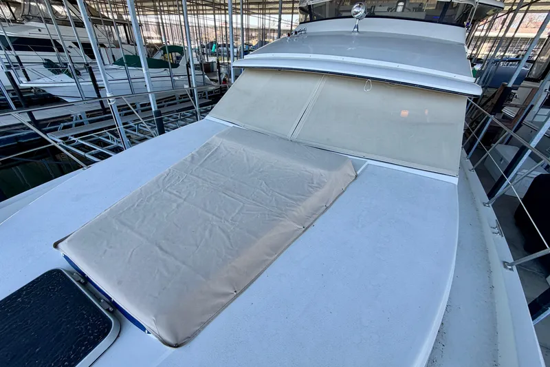 Slide: The Image of 1987 Carver 4207 Aft Cabin Motor Yacht docked in a marina, covered deck visible. - 6