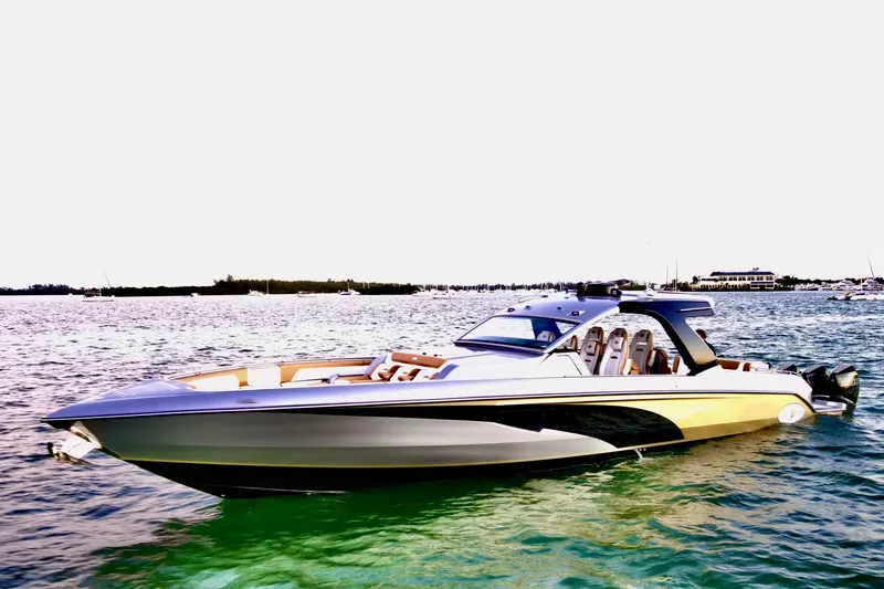 Slide: The Image of 2026 Cigarette Thunder boat cruising near city skyline at sunset. - 2