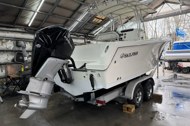 Slide: The Image of 2022 Sailfish 242 CC boat with Mercury engine on trailer in garage. - 11