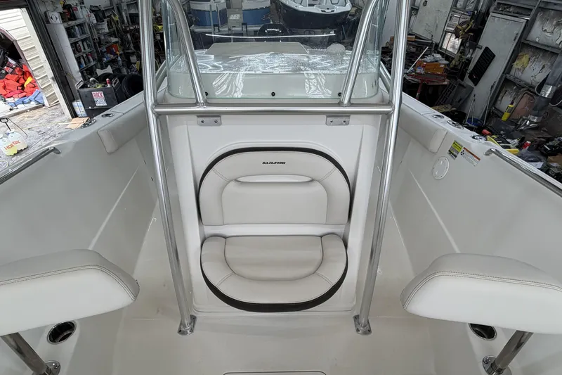Slide: The Image of 2022 Sailfish 242 CC boat interior with white seating and stainless steel frame. - 14