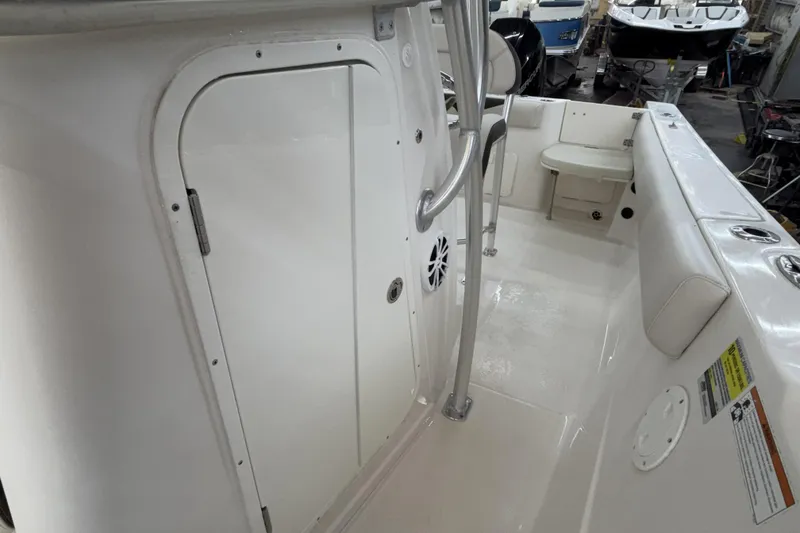 Slide: The Image of 2022 Sailfish 242 CC boat interior with seating and storage compartments. - 16