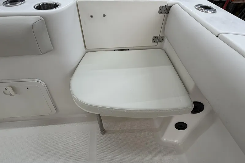 Slide: The Image of 2022 Sailfish 242 CC boat interior with foldable seat and cup holders. - 19