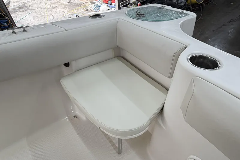 Slide: The Image of 2022 Sailfish 242 CC boat interior with cushioned seating and cup holder. - 20