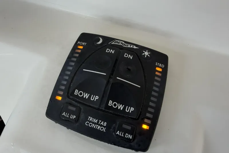 Slide: The Image of Bennett trim tab control panel on 2022 Sailfish 242 CC boat. - 23