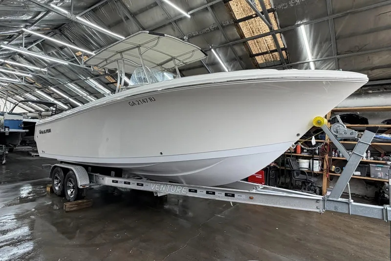 Slide: The Image of 2022 Sailfish 242 CC boat on trailer in indoor storage facility. - 7
