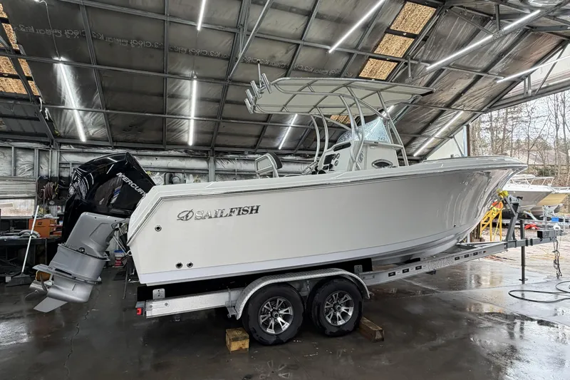 Slide: The Image of 2022 Sailfish 242 CC boat on trailer in a workshop setting. - 8
