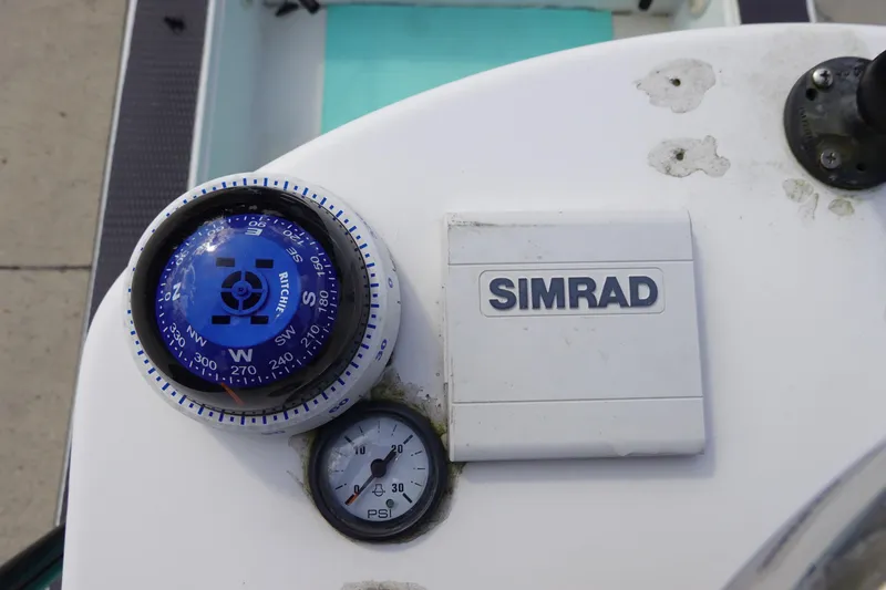 Slide: The Image of Compass and Simrad equipment on 1999 Stott Craft 1900 boat dashboard. - 10