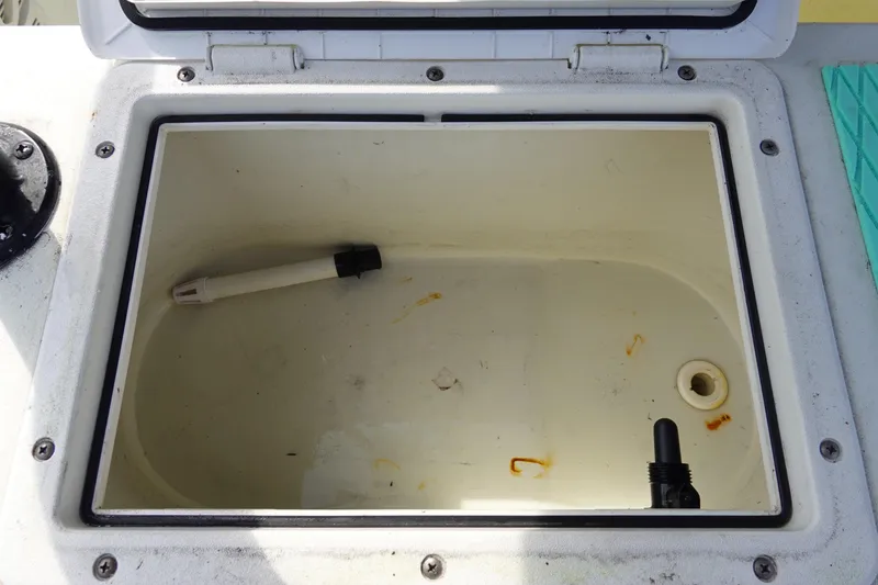 Slide: The Image of Open storage compartment on a 1999 Stott Craft 1900 boat, showing interior details. - 14