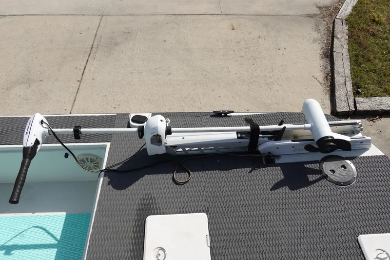 Slide: The Image of 1999 Stott Craft 1900 boat with trolling motor on deck, parked on concrete. - 19