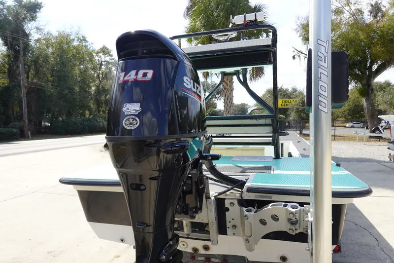 Slide: The Image of Stott Craft 1900 boat with Suzuki 140 outboard motor, 1999 model, parked outdoors. - 5