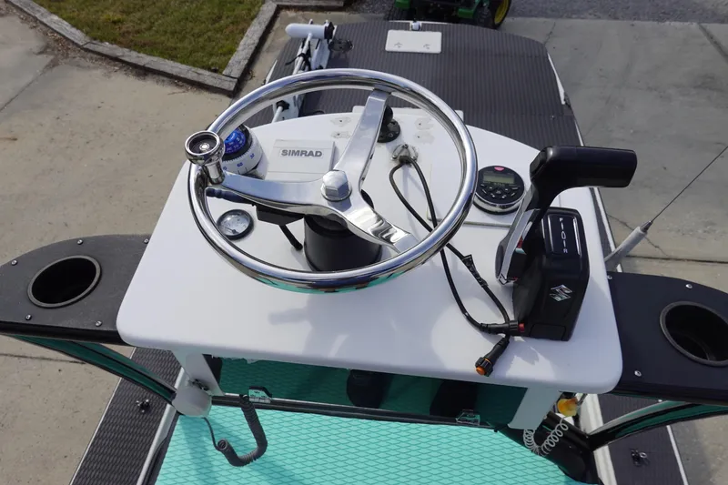 Slide: The Image of Stott Craft 1900 boat helm with steering wheel and controls, 1999 model. - 8