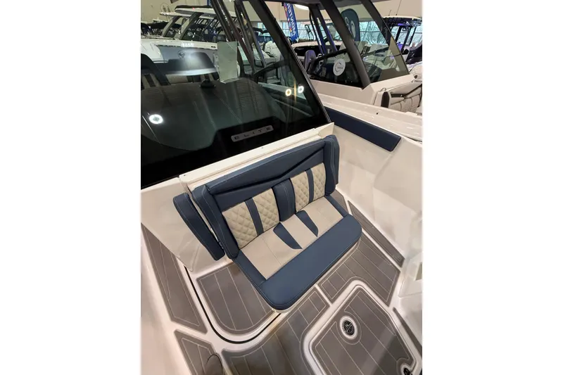 Slide: The Image of 2026 Monterey Elite 27 OB boat interior with blue and beige seating, modern design. - 10