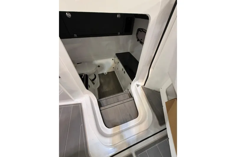 Slide: The Image of 2026 Monterey Elite 27 OB boat interior with compact bathroom and modern design. - 11