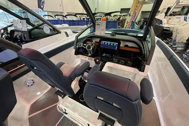 Slide: The Image of Interior of 2026 Monterey Elite 27 OB boat with modern dashboard and seating. - 7