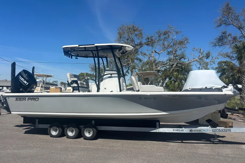 Slide: The Image of 2019 Sea Pro 248 Bay boat on trailer, featuring Suzuki outboard motor. - 1