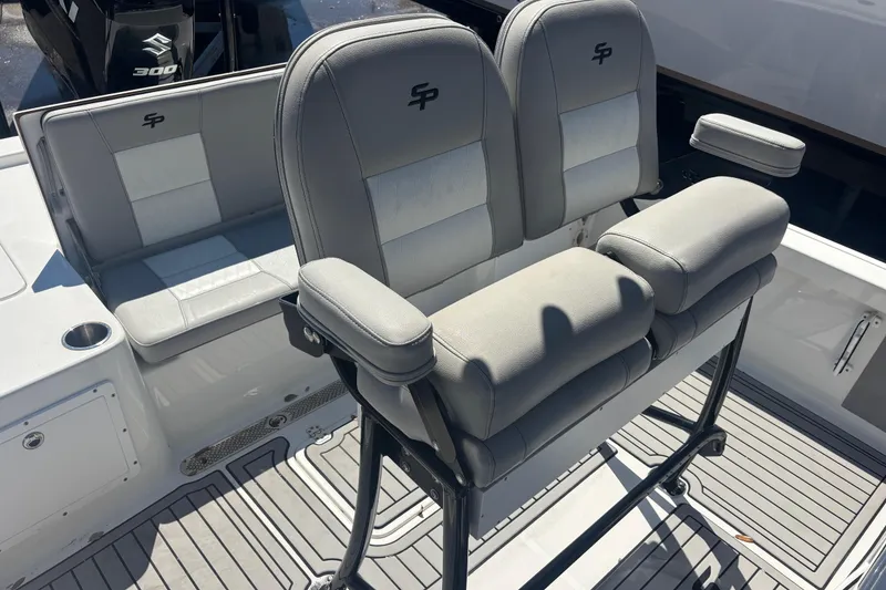 Slide: The Image of 2019 Sea Pro 248 Bay boat seating with dual helm chairs and cushioned bench. - 13