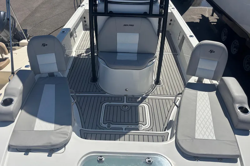 Slide: The Image of 2019 Sea Pro 248 Bay boat interior with gray seating and deck layout. - 14