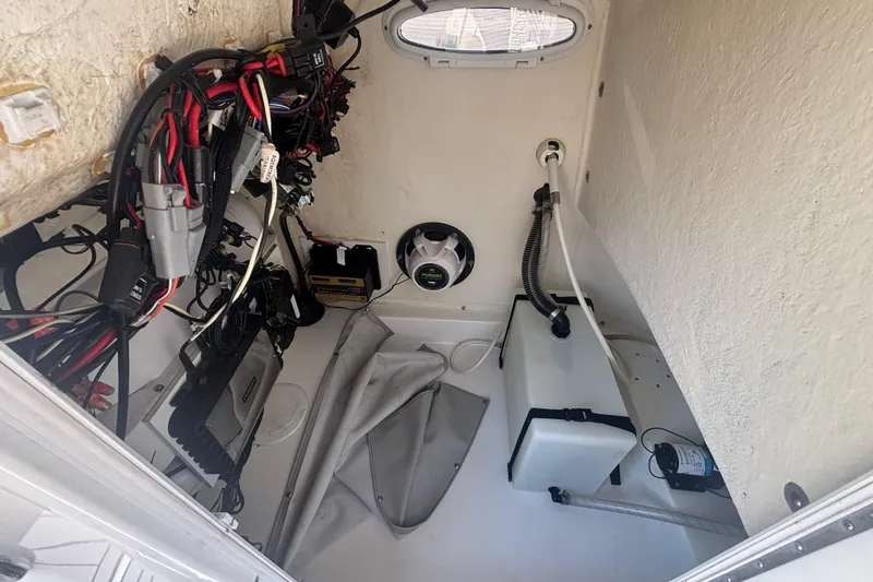 Slide: The Image of 2019 Sea Pro 248 Bay boat interior wiring and storage compartment. - 15