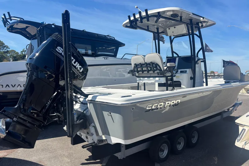 Slide: The Image of 2019 Sea Pro 248 Bay boat with Suzuki outboard motor, displayed outdoors. - 2