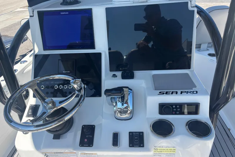 Slide: The Image of 2019 Sea Pro 248 Bay boat dashboard with steering wheel and electronic controls. - 6