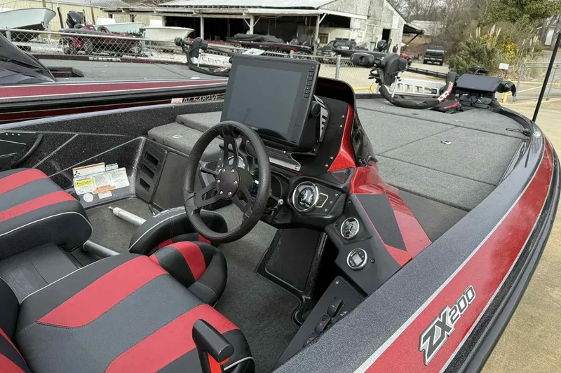 Slide: The Image of 2019 Skeeter ZX200 boat interior with steering wheel and control panel. - 13