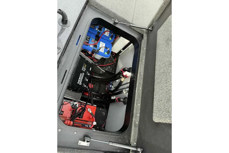 Slide: The Image of 2019 Skeeter ZX200 boat battery compartment with wiring and charger. - 9