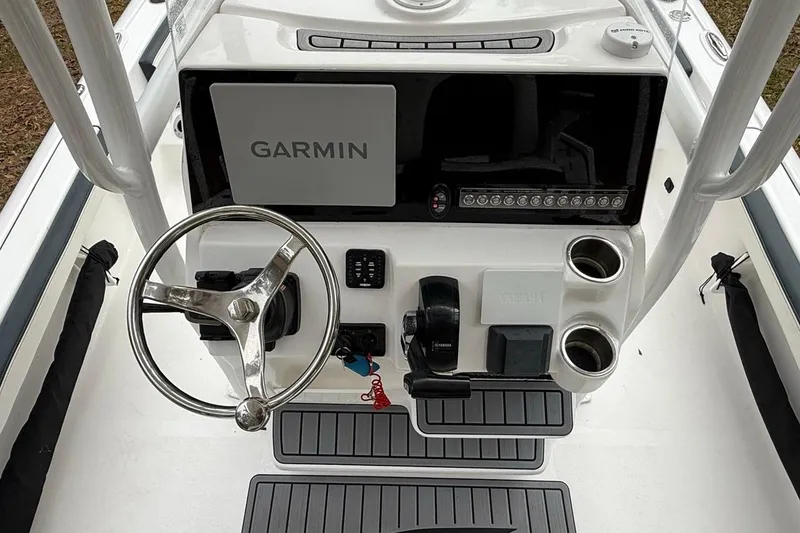 Slide: The Image of 2024 Tidewater 2300 Carolina Bay boat console with Garmin display and steering wheel. - 15