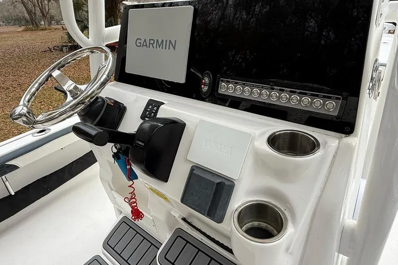 Slide: The Image of 2024 Tidewater 2300 Carolina Bay boat console with Garmin display and Yamaha controls. - 16