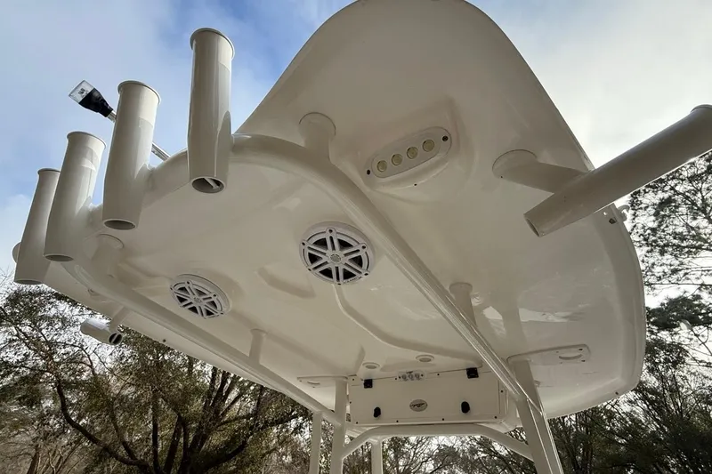Slide: The Image of 2024 Tidewater 2300 Carolina Bay boat underside with rod holders and speakers. - 19