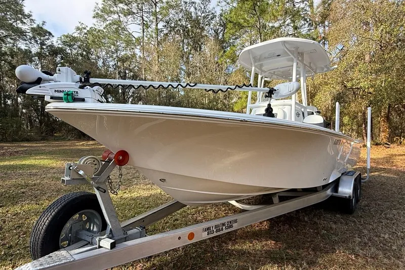 Slide: The Image of 2024 Tidewater 2300 Carolina Bay boat on trailer in wooded area. - 2