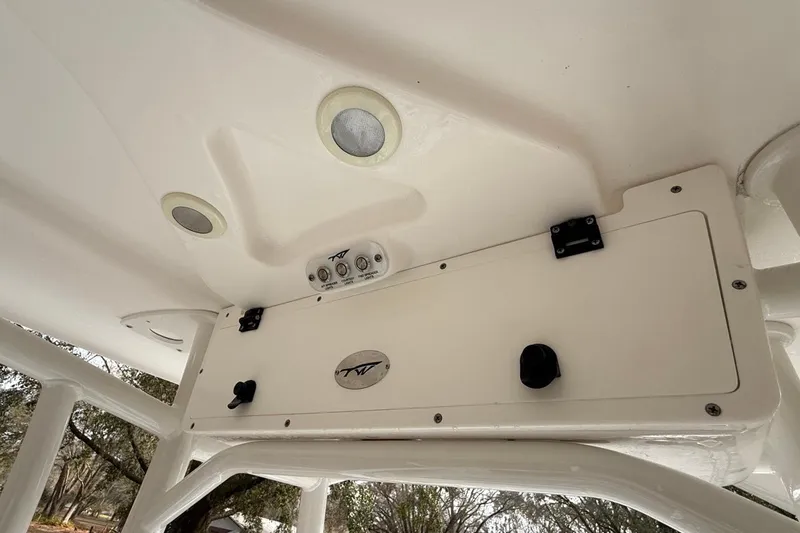Slide: The Image of 2024 Tidewater 2300 Carolina Bay boat console with built-in speakers and controls. - 21