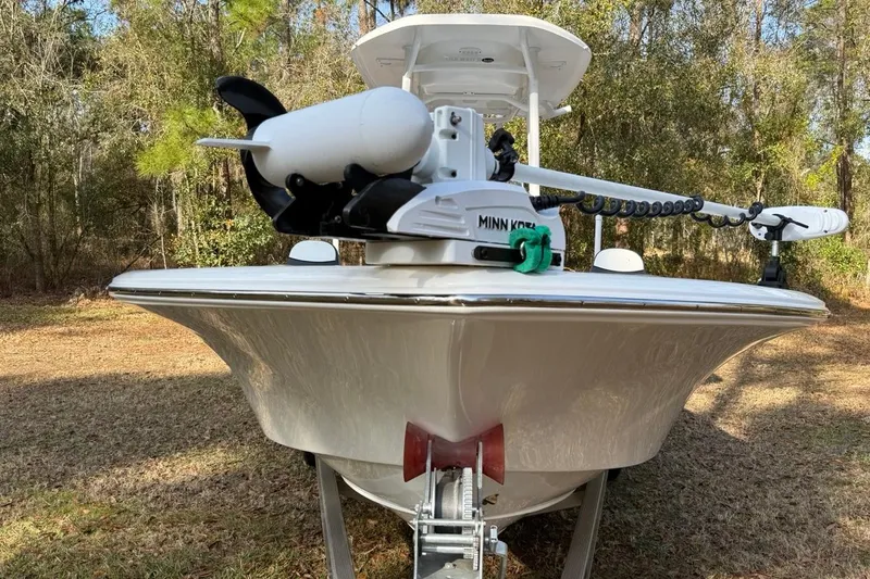Slide: The Image of 2024 Tidewater 2300 Carolina Bay boat with Minn Kota trolling motor in wooded area. - 3