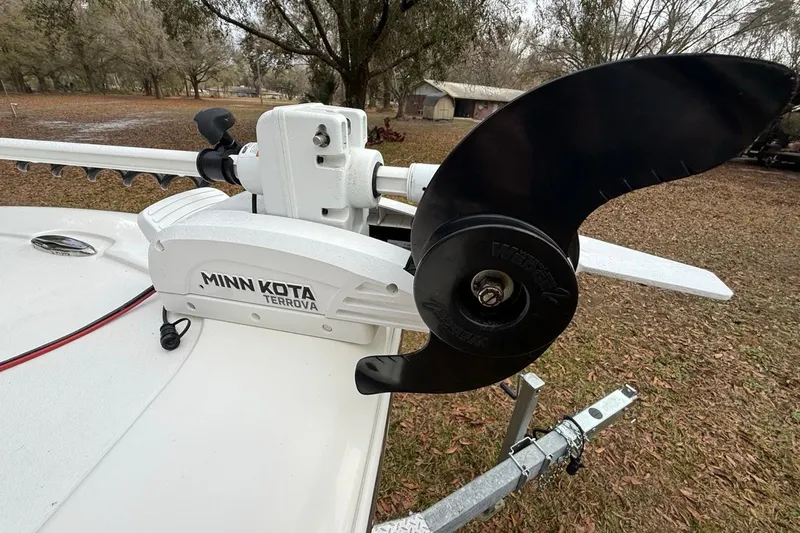 Slide: The Image of 2024 Tidewater 2300 Carolina Bay with Minn Kota Terrova trolling motor in a wooded area. - 31