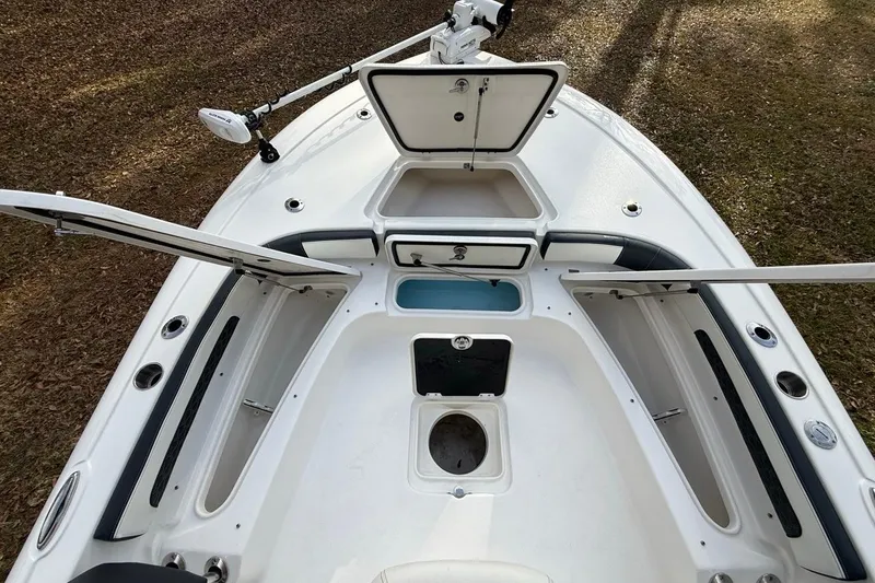 Slide: The Image of 2024 Tidewater 2300 Carolina Bay boat interior with open storage compartments and fishing rod holders. - 33