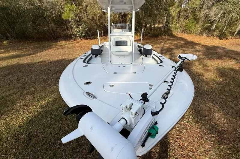 Slide: The Image of 2024 Tidewater 2300 Carolina Bay boat on grassy area, featuring a sleek white deck design. - 36